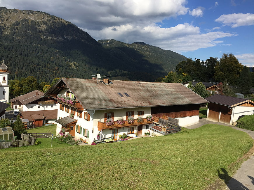Traditional Alpine Farmhouse with Mountain Backdrop