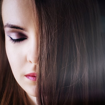Close-up portrait of a young woman with eyes closed