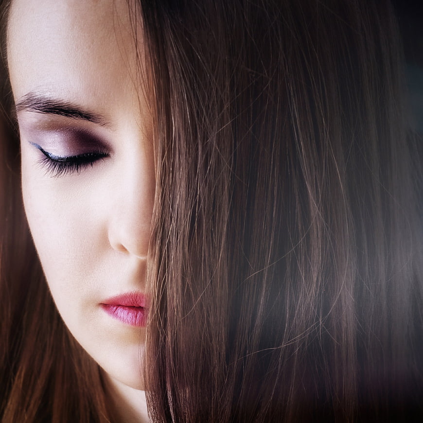 Close-up portrait of a young woman with eyes closed