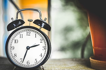 Vintage Black Alarm Clock on Wooden Surface