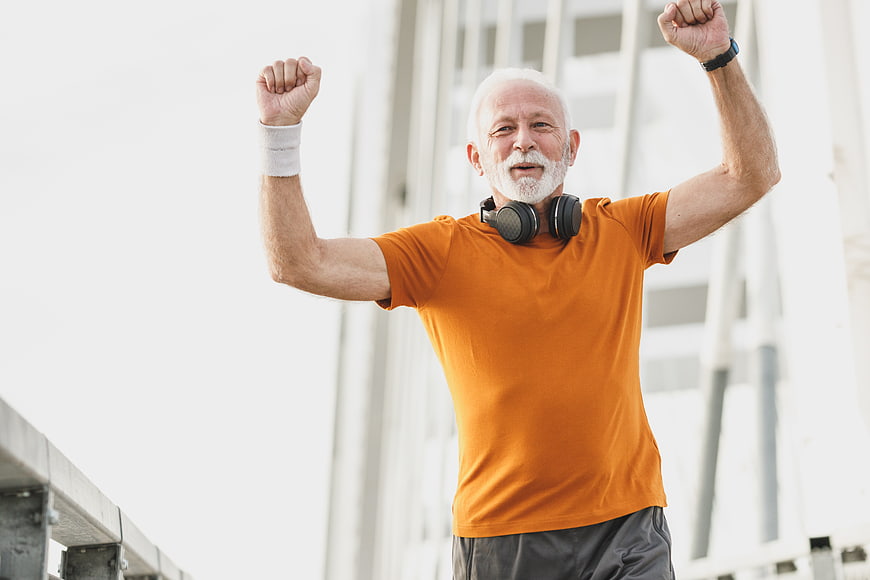 Happy Senior Man Celebrating Fitness Success Outdoors