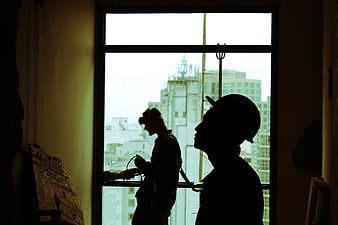 Silhouettes of construction workers in a high-rise building