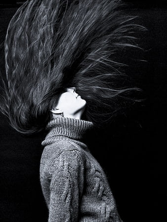 Woman with flying hair in black and white