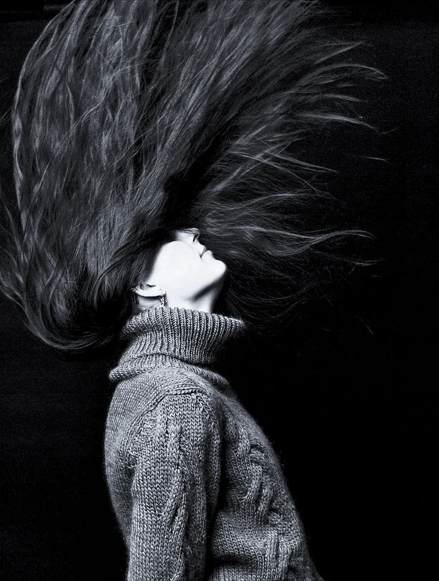 Woman with flying hair in black and white