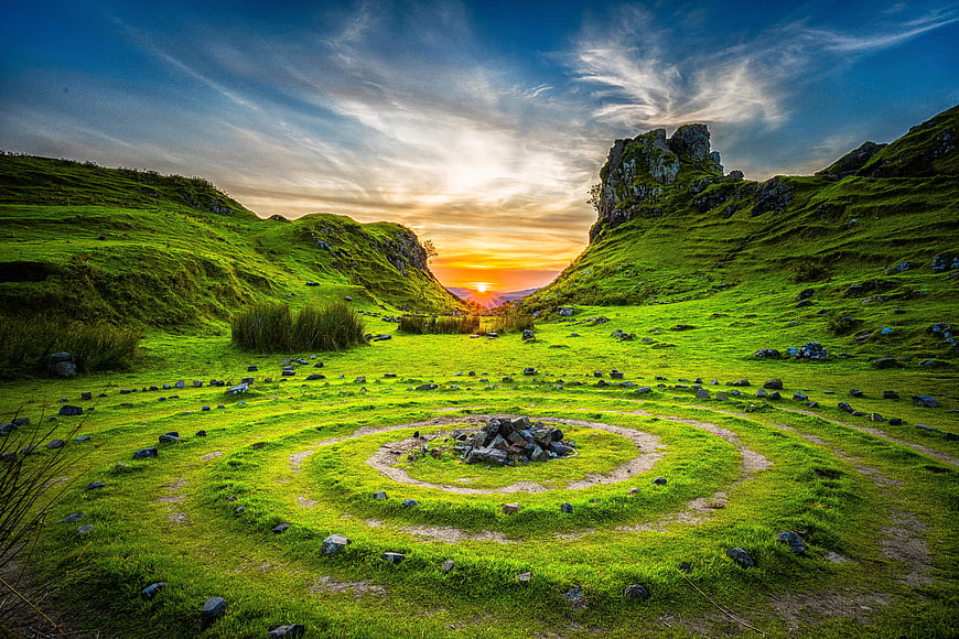 Ancient Stone Spiral Circle in Green Scottish Landscape at Sunset