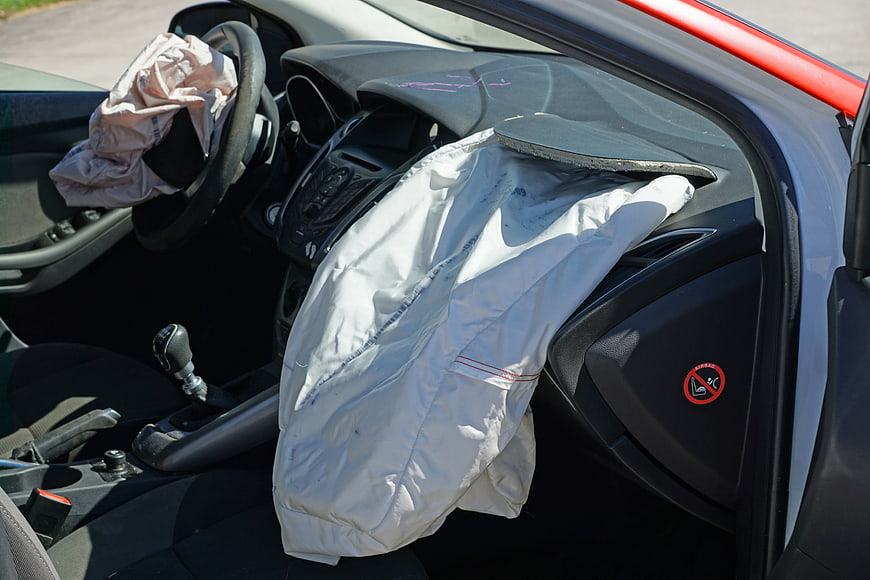 Deployed car airbags inside vehicle after crash test