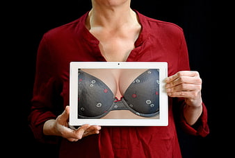 Woman Holding Tablet Displaying Bra Image
