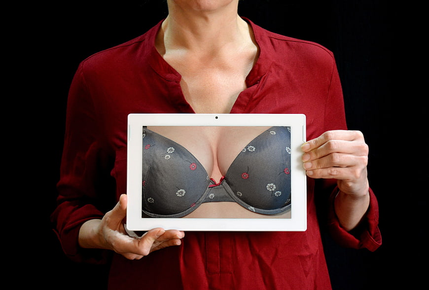 Woman Holding Tablet Displaying Bra Image