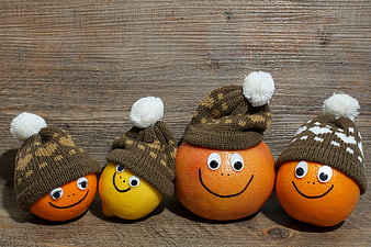 Cute Citrus Fruits Wearing Knitted Winter Hats on Rustic Wood