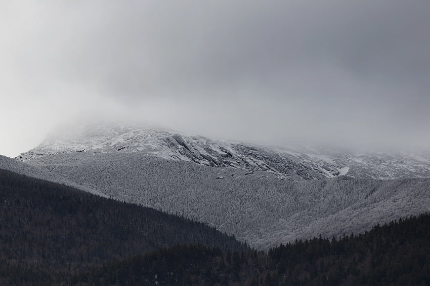 Snowy Mountain Peak with Fog and Forest