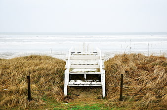 White wooden beach access stairs leading to ocean