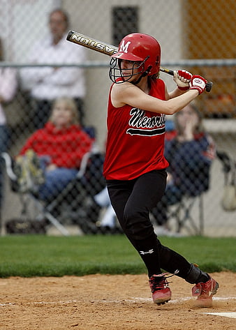 Female Softball Player Swinging Bat on Dirt Field