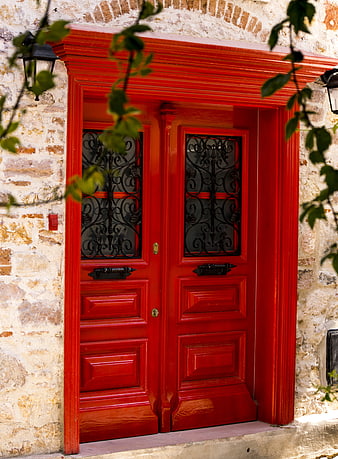Vibrant Red Wooden Double Door in Stone Wall