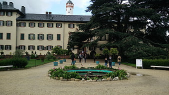 Historic Castle Courtyard with Fountain and Visitors