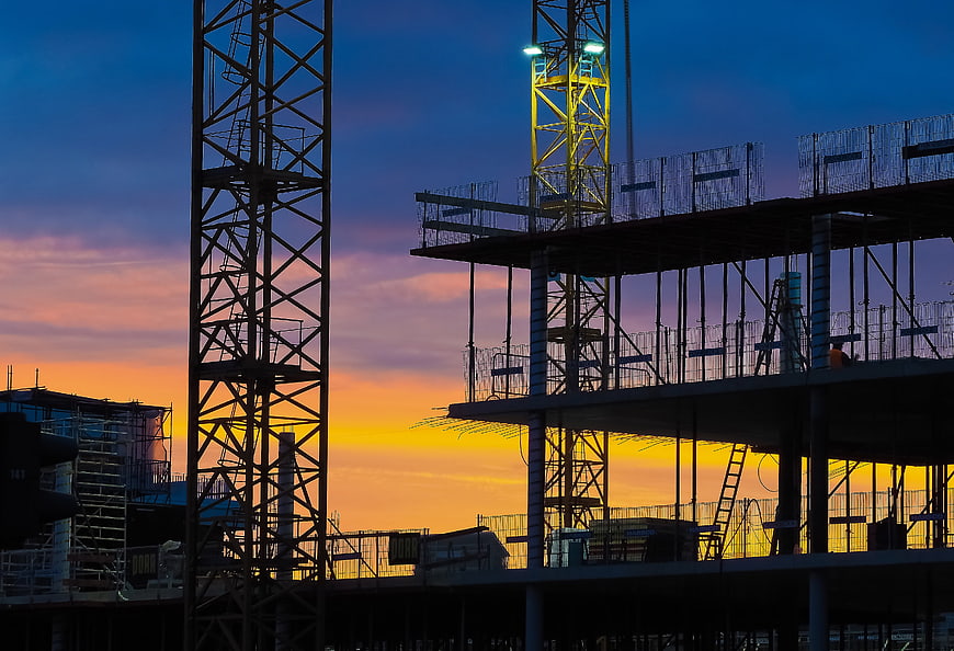 Construction Site Silhouette Against Vibrant Sunset Sky