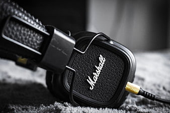 Close-up of black Marshall headphones on textured surface