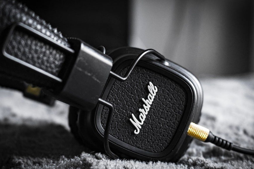 Close-up of black Marshall headphones on textured surface