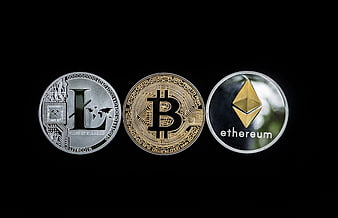 Physical Litecoin, Bitcoin, and Ethereum coins on black background