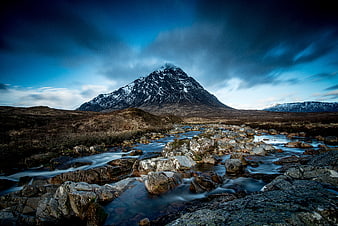 Dramatic Snow-Capped Mountain Peak with Flowing River