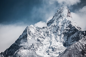 Majestic Snow-Capped Mountain Peak with Dramatic Clouds