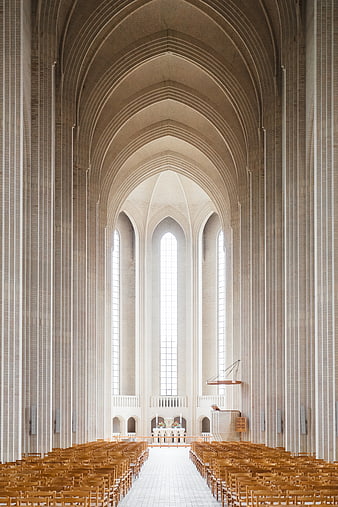 Modern Cathedral Interior with High Arched Ceilings and Wooden Pews