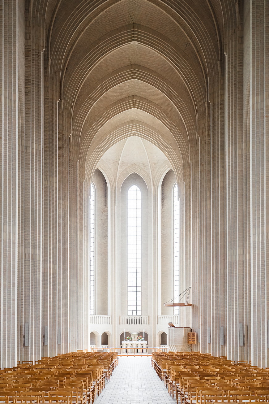 Modern Cathedral Interior with High Arched Ceilings and Wooden Pews