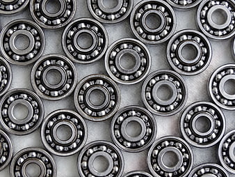 Top view of silver ball bearings arranged on metal surface