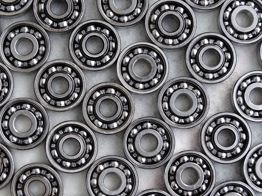 Top view of silver ball bearings arranged on metal surface
