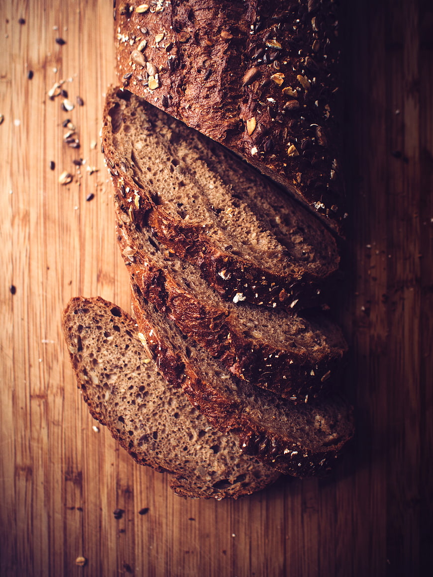Sliced Whole Grain Bread on Wooden Board