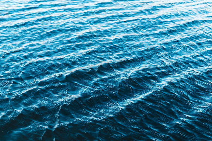 Deep blue ocean water surface with gentle ripples and waves