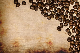 Roasted Coffee Beans Scattered on Textured Beige Linen Background