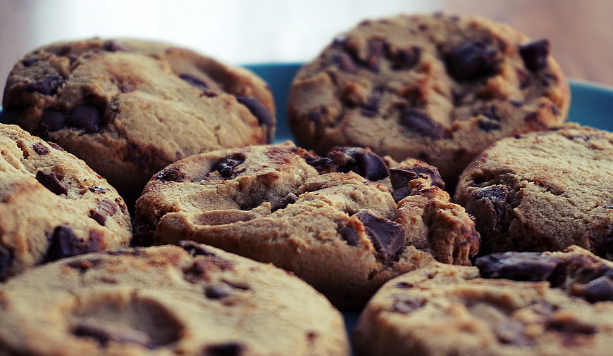 Close-up of freshly baked chocolate chip cookies on a blue plate