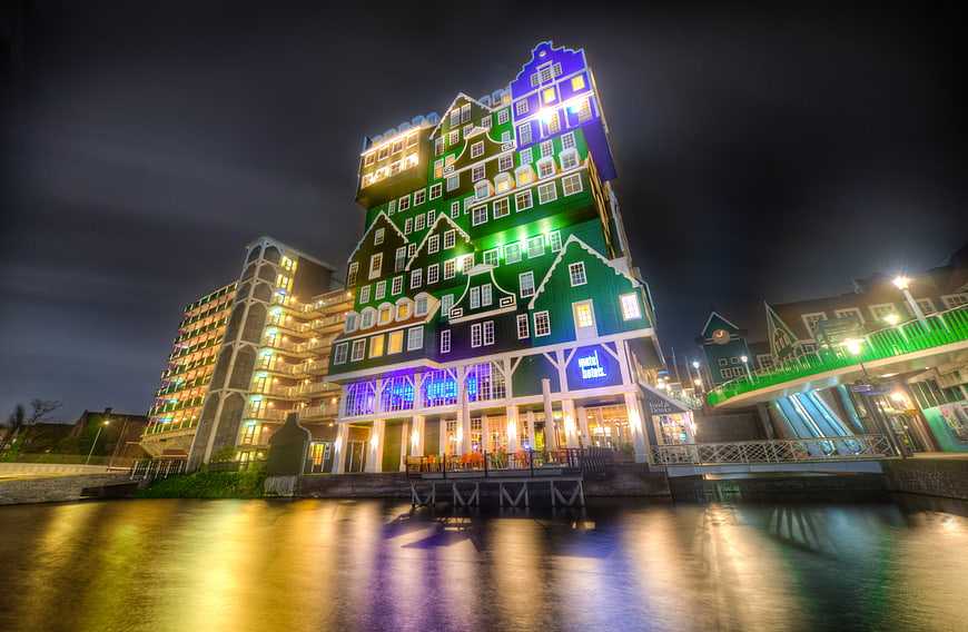 Colorful Dutch Hotel Building at Night with Water Reflection