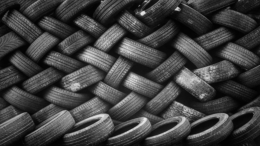 Black and white texture of stacked used tires