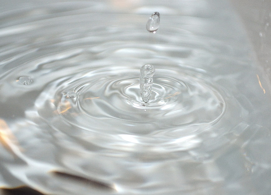 Macro Water Droplet Splash With Ripples And Crown Formation