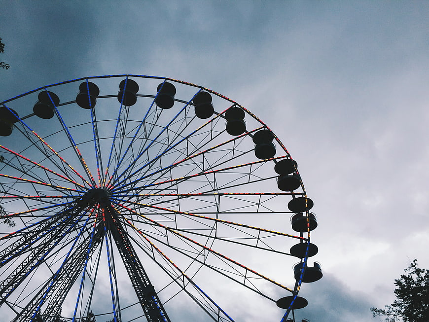 Ferris Wheel Silhouette Against Cloudy Sky