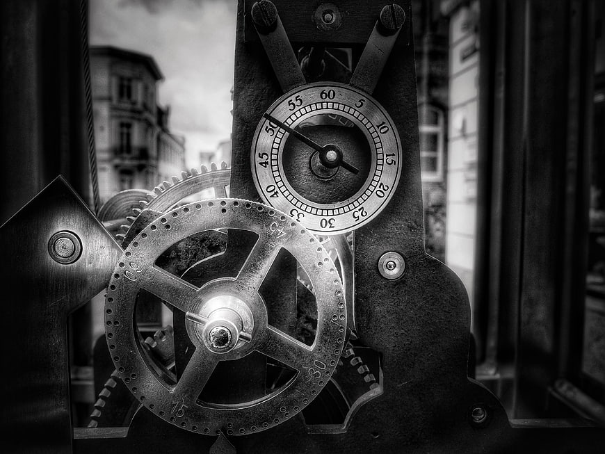 Vintage mechanical clock gears and dial in black and white