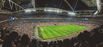 Wide Angle View of Packed Football Stadium at Night
