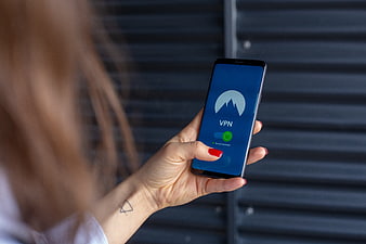 Woman holding smartphone with VPN app interface