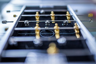 Close-up of Miniature Foosball Table with Gold Players