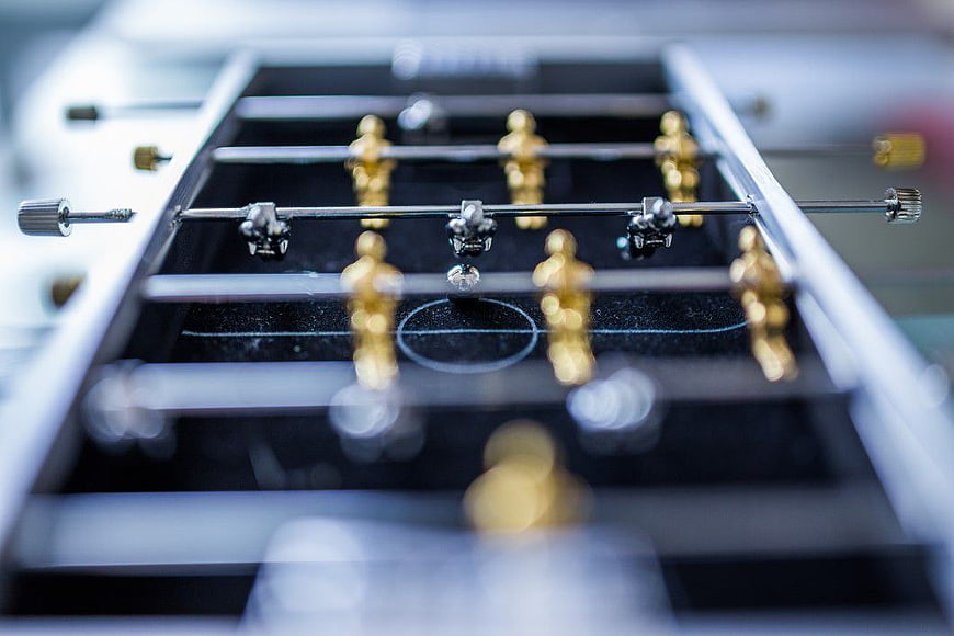 Close-up of Miniature Foosball Table with Gold Players