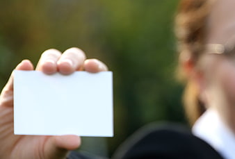 Hand holding blank white business card mockup
