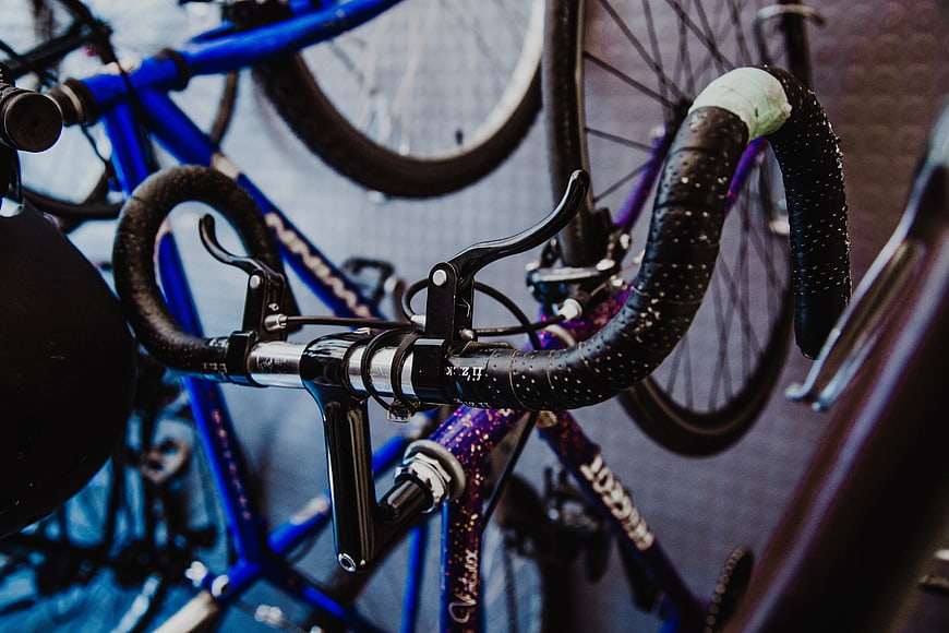 Close-up of black road bike handlebars with brake levers