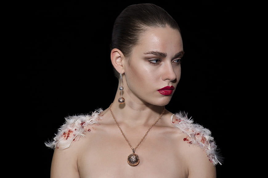High-Fashion Portrait of Woman with Red Lips and Feathered Shoulders
