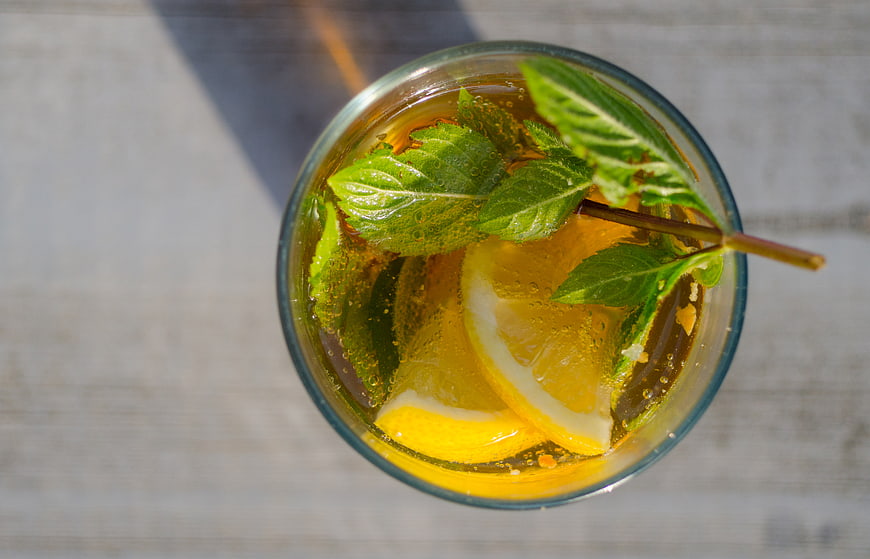 Top view of refreshing lemon mint drink with straw