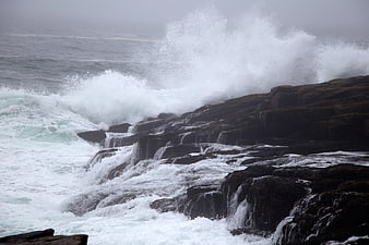 Powerful Ocean Waves Crashing Against Rocky Coastline