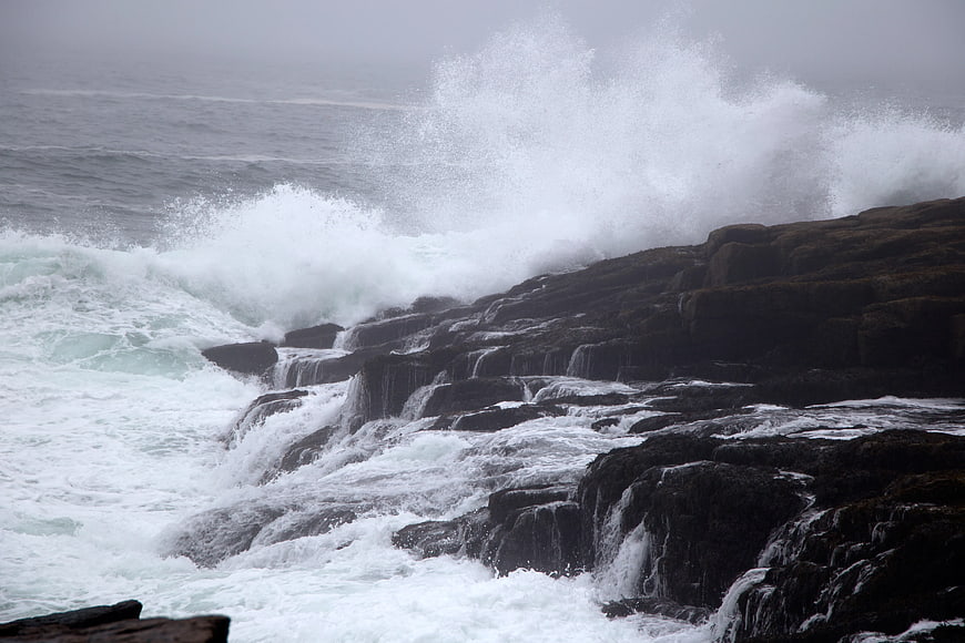 Powerful Ocean Waves Crashing Against Rocky Coastline
