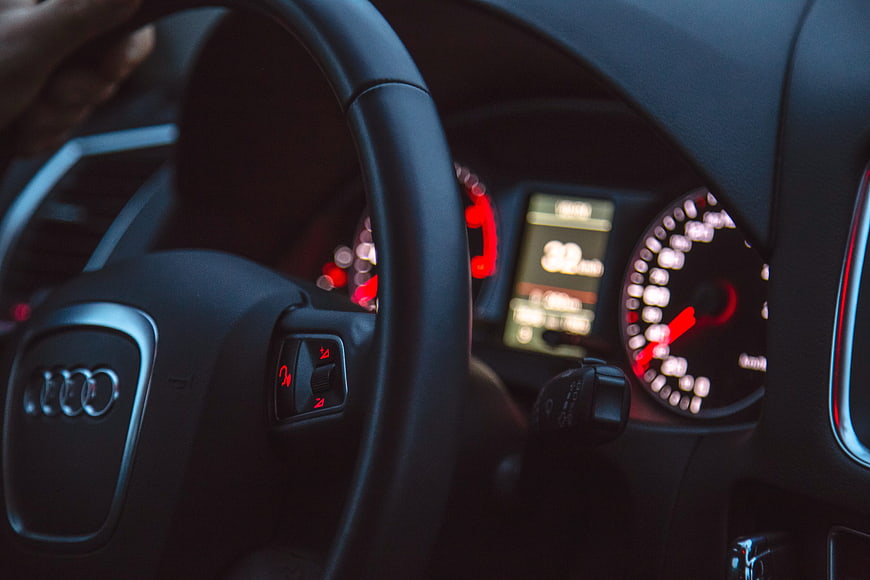 Close-up of Audi steering wheel and dashboard at night