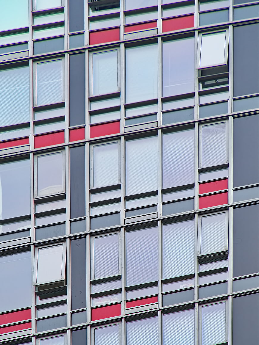 Modern Building Facade with Red and Gray Window Grid