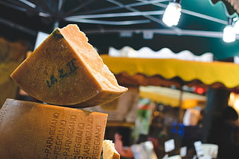 Close-up of Parmigiano Reggiano cheese wedge at market